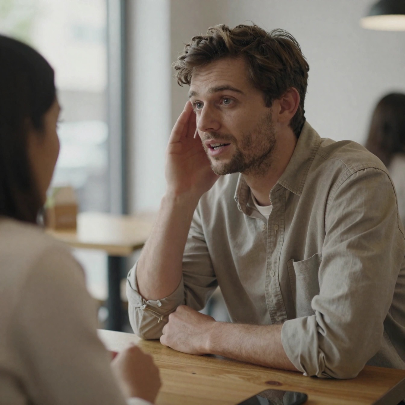 Come Sembrare Più Adulto da Uomo: Guida Pratica 2026 5 Uomo che ascolta attentamente durante una conversazione al caffè, esempio di comunicazione matura e ascolto empatico